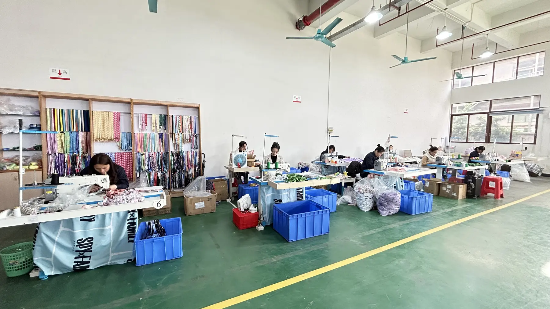 Actual LANYVO lanyard sewing and assembly workstations with production components