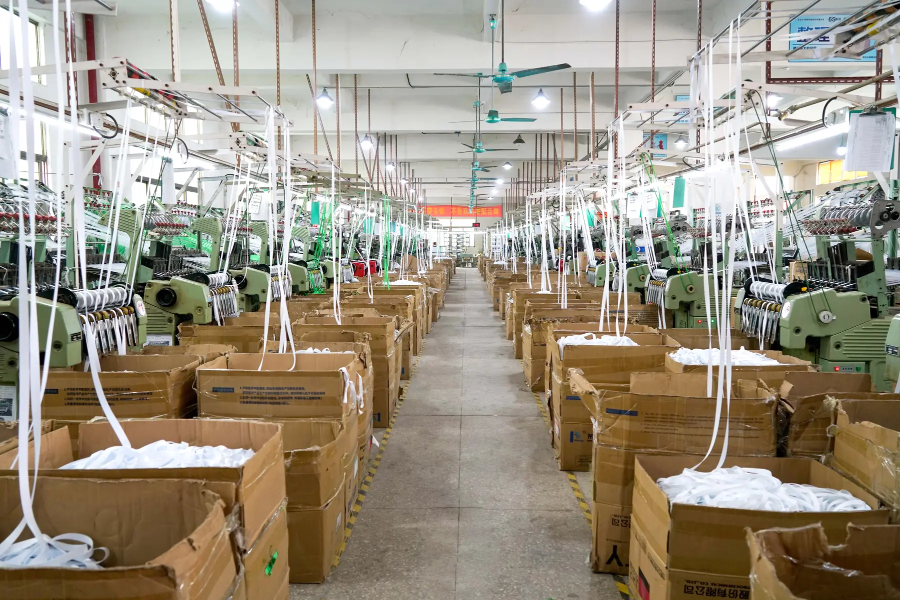 LANYVO-supplied workshop photo of narrow-webbing weaving machines and strap material